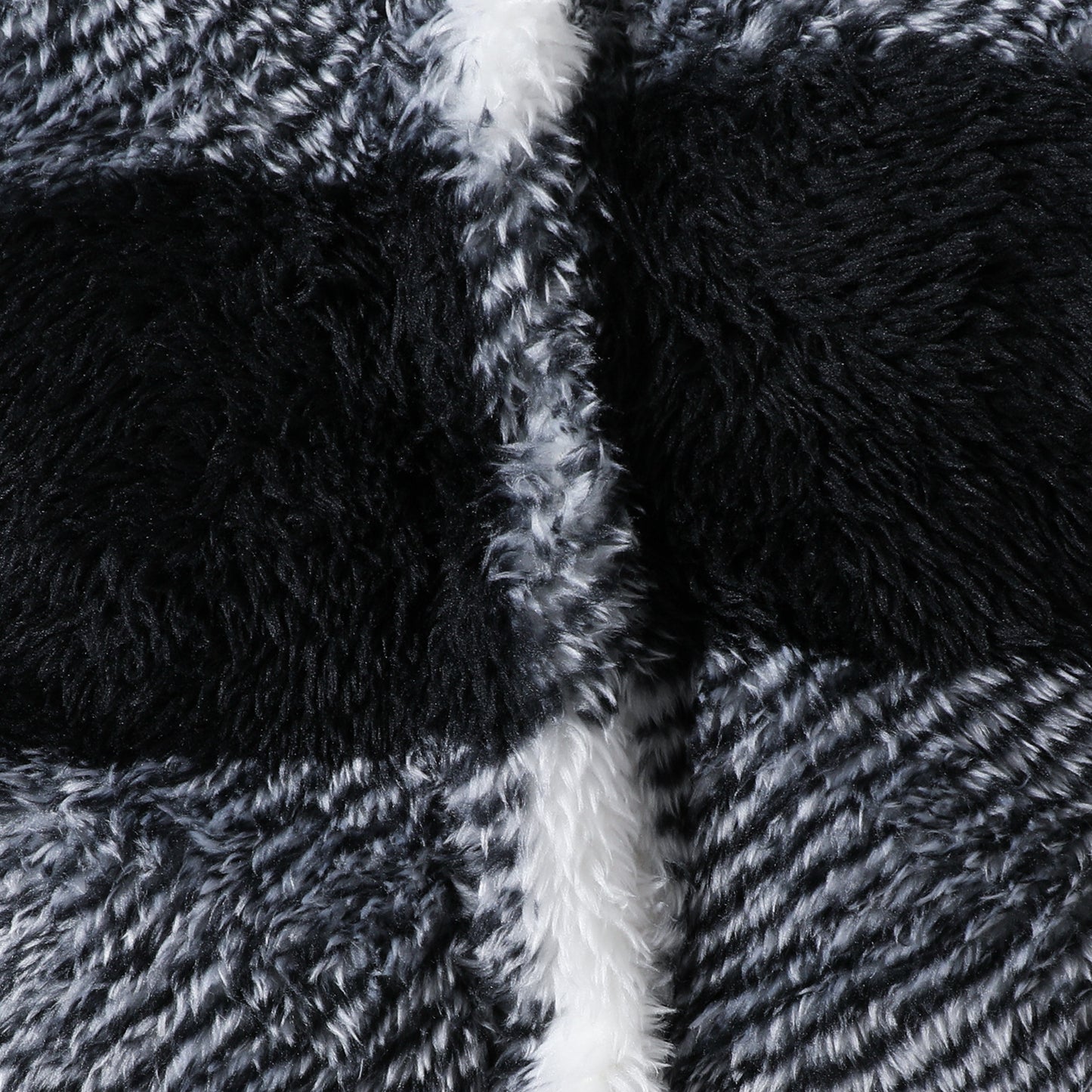 Close-up of black and gray textured fabric with a white stripe.