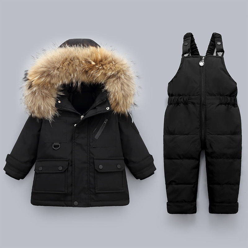 Black winter coat with fur hood and black snow pants on a gray background
