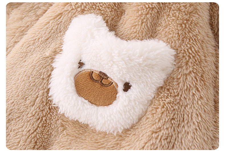 Close-up of a plush bear face on a soft textured background