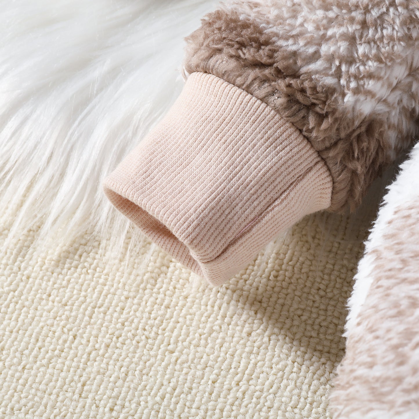 Close-up of a cuff knitted warmer on a textured surface
