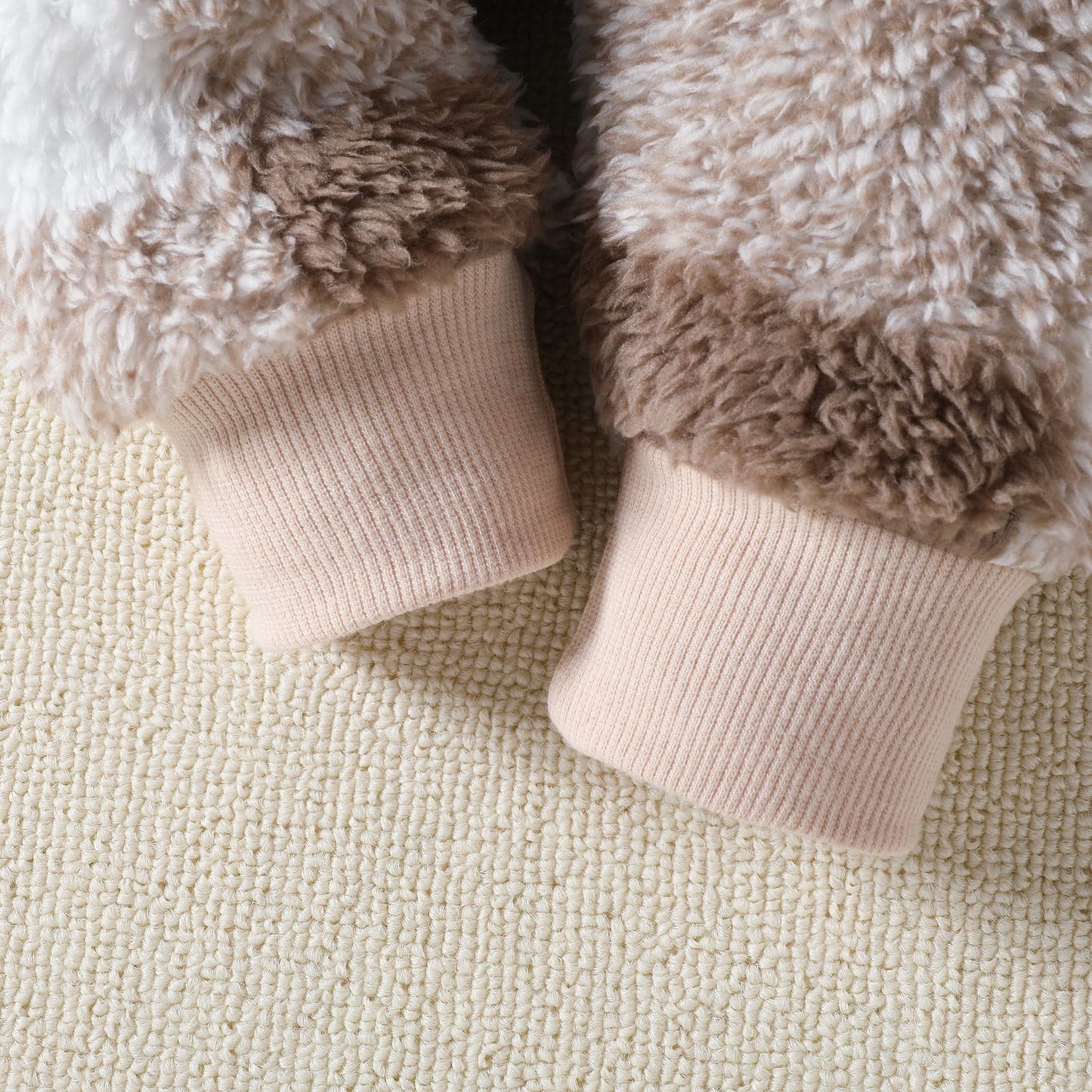 Close-up of fluffy cuffs on a textured surface