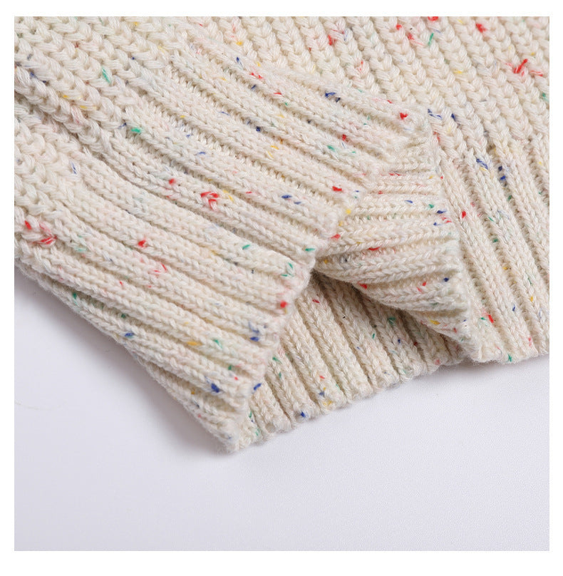 Close-up of a textured fabric with colorful speckles on a white background