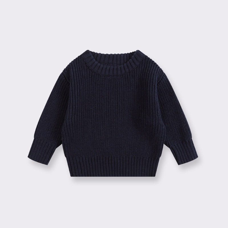 Black knit sweater on a light gray background