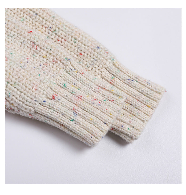 Close-up of a textured fabric with colorful specks on a white background