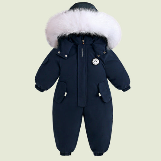 Navy blue baby snowsuit with white fur hood on a beige background