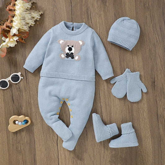 Baby blue outfit set with bear design on a wooden surface