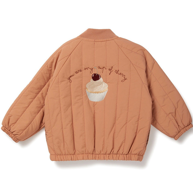 Brown quilted jacket with cupcake design and text on a white background