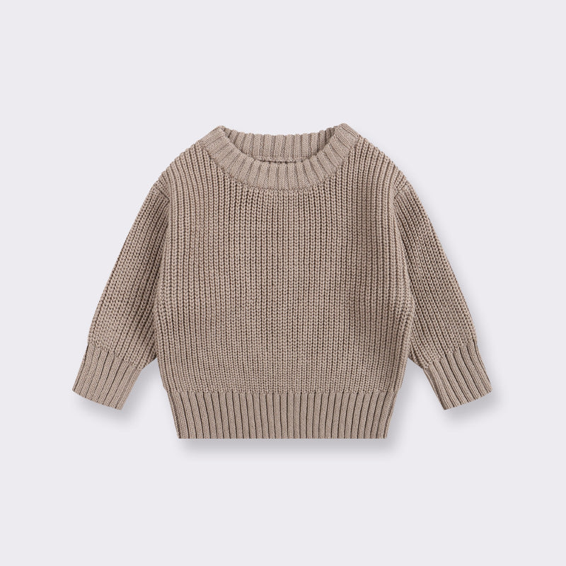 Beige knitted sweater on a light gray background