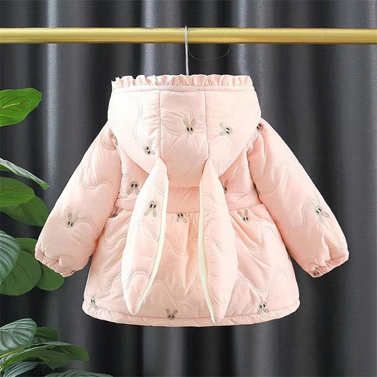 Pink puffer jacket on a hanger against a dark curtain background