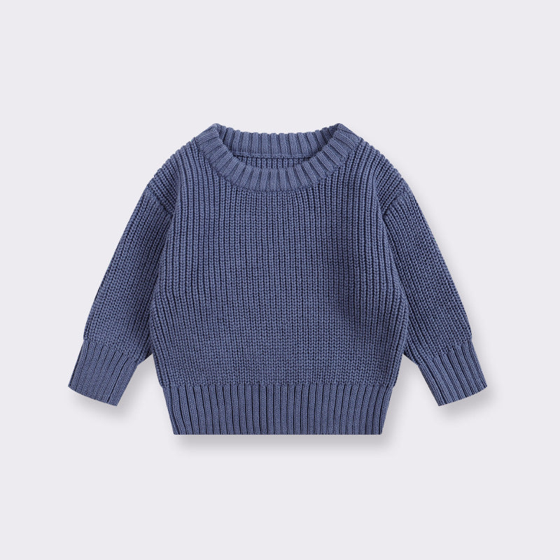 Blue knitted sweater on a light gray background
