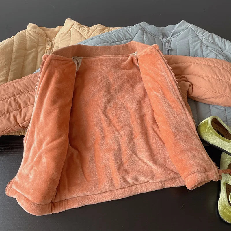 Stack of colorful jackets on a dark surface