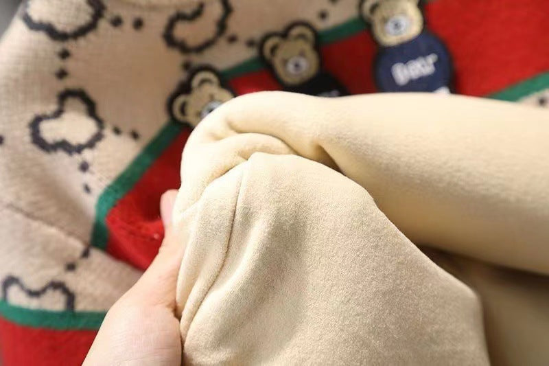 Close-up of beige fabric held by a hand with a patterned background