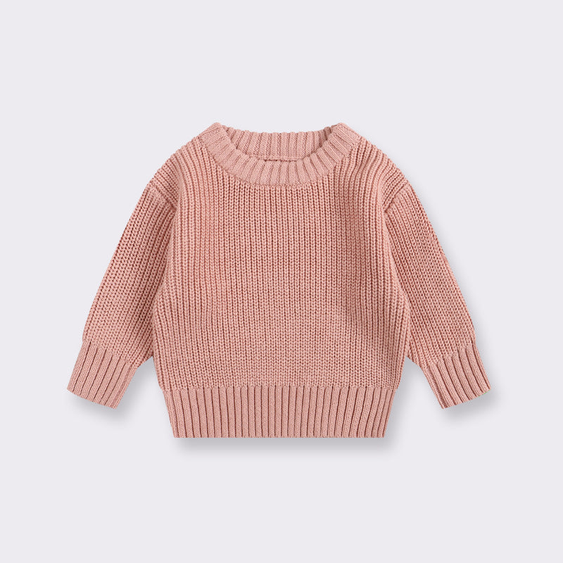 Pink knitted sweater on a light gray background