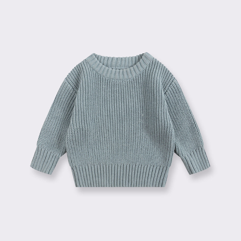Light blue knitted sweater on a light gray background