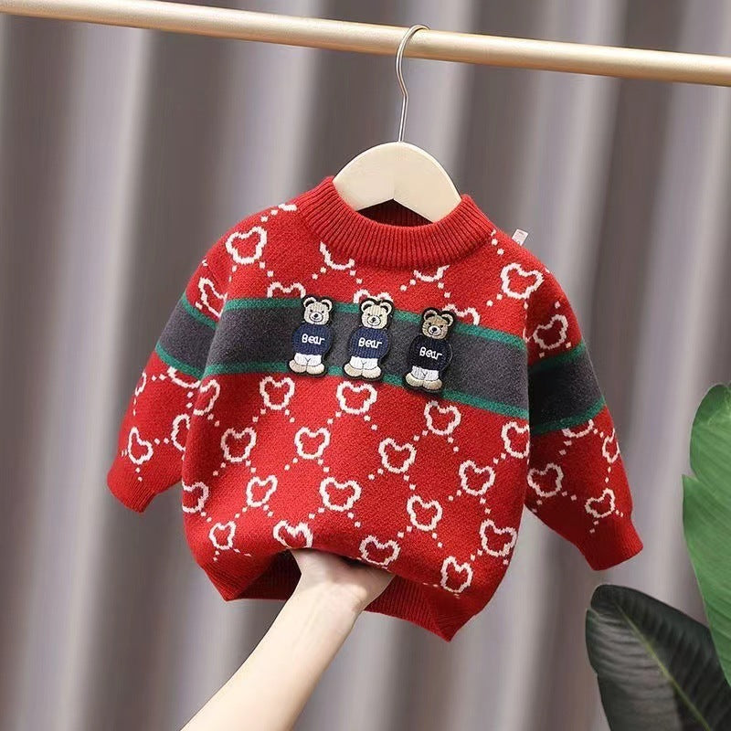 Red sweater with bear pattern on a hanger against a neutral background