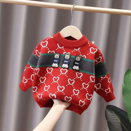 Red sweater with bear pattern on a hanger against a neutral background