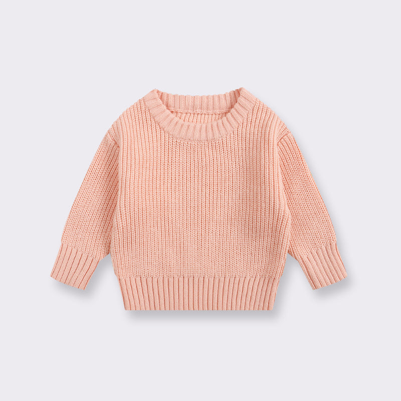 Pink sweater on a light gray background
