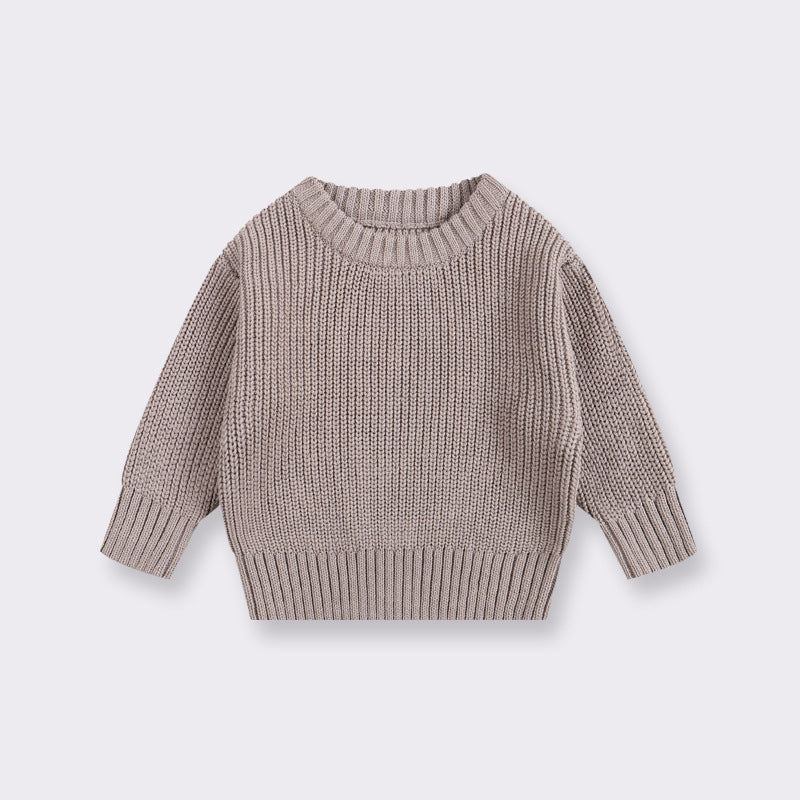 Brown knitted sweater on a light gray background