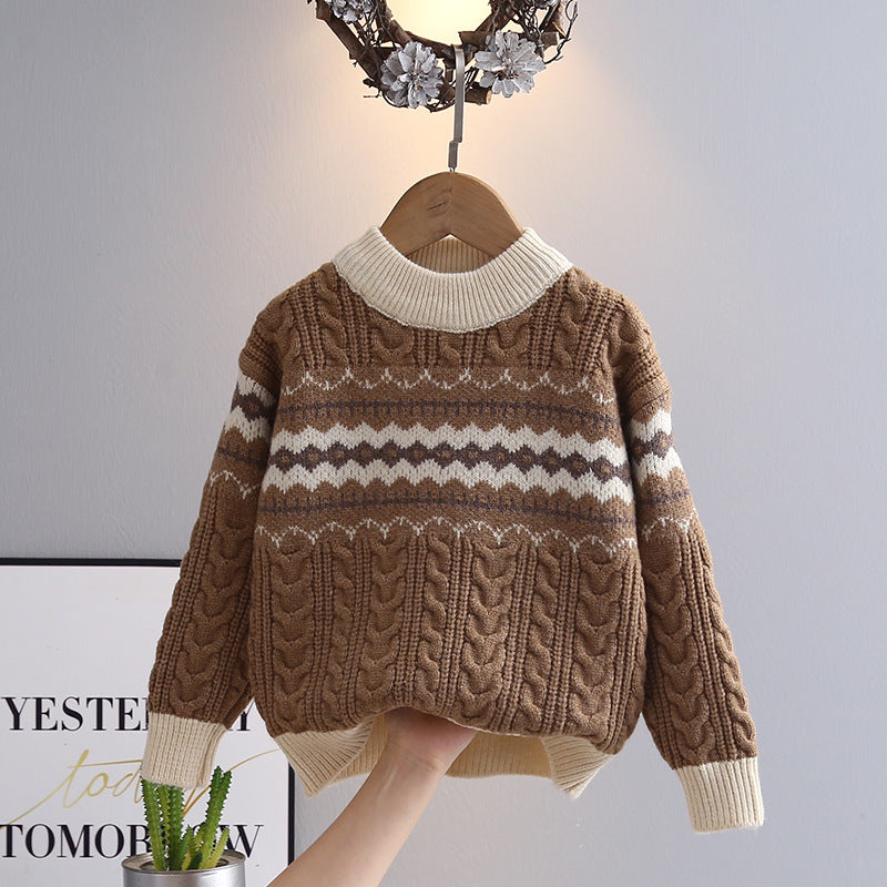 Brown and white patterned sweater on a hanger against a neutral background