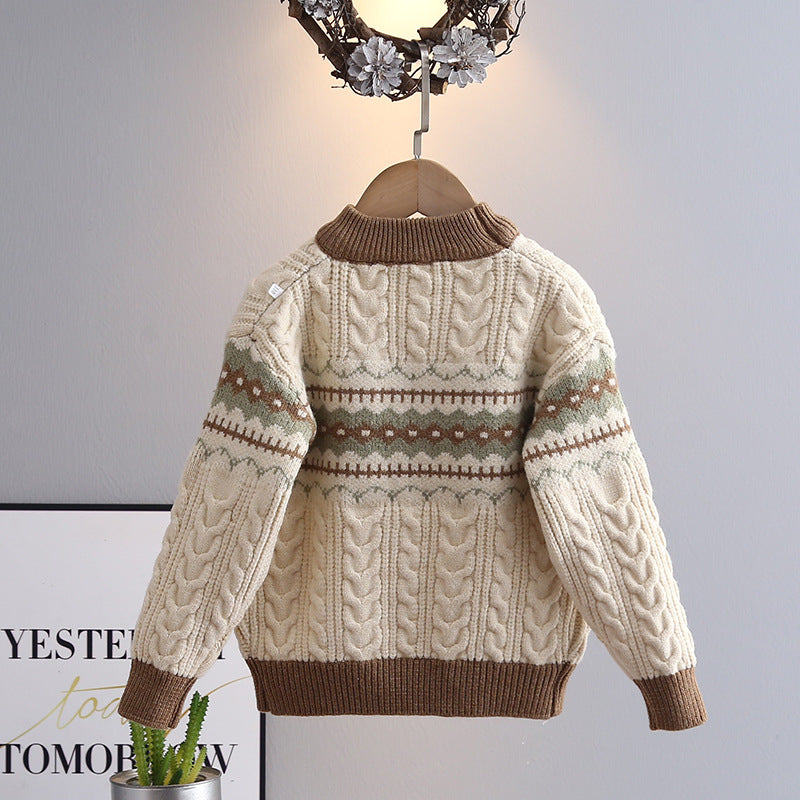 Knitted sweater with brown accents on a hanger against a neutral background