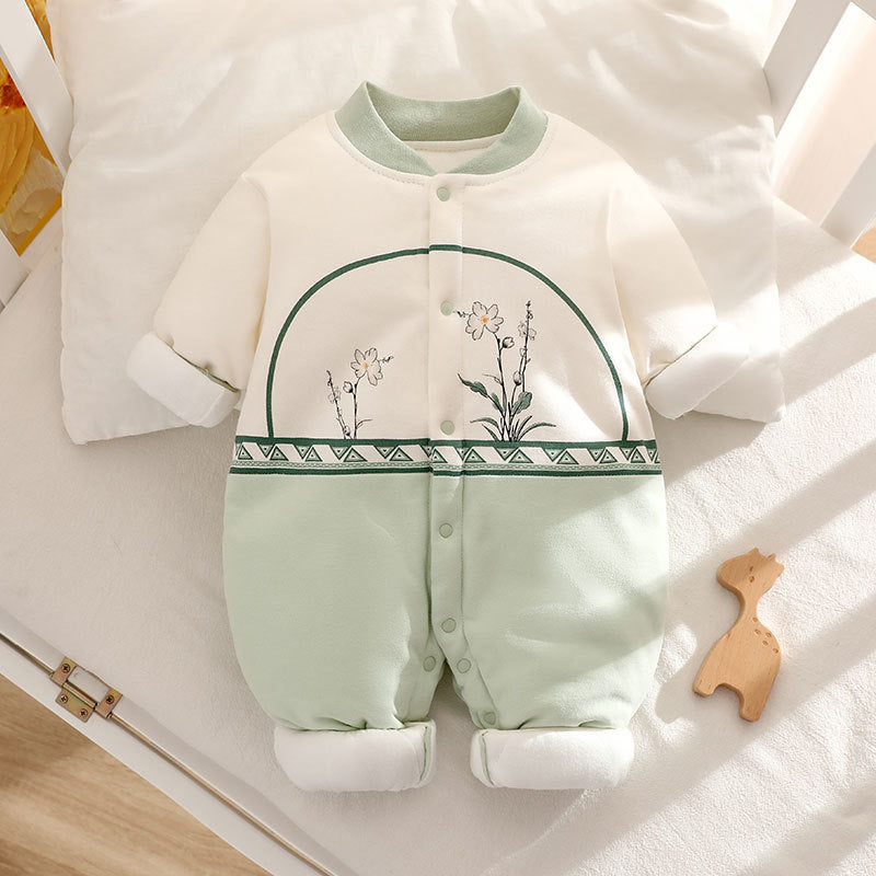 Baby romper with floral design on a white surface