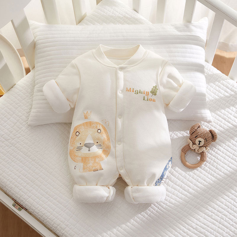 Baby onesie with lion design and rattle on a crib