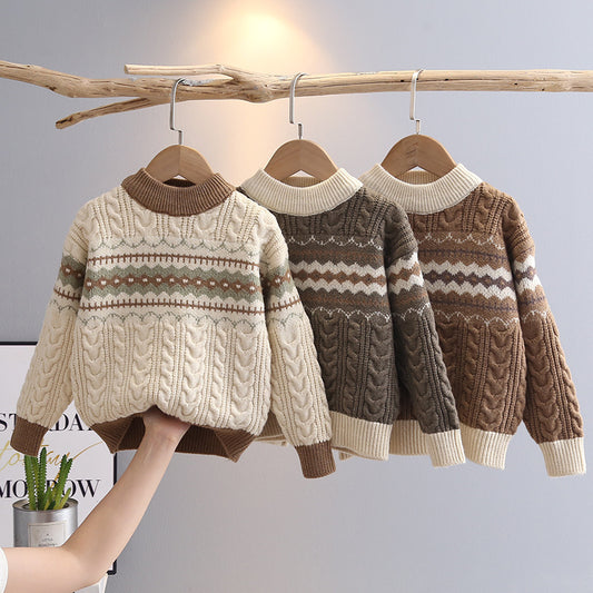 Three children's sweaters in beige, brown, and a mix of both on hangers against a light gray background.