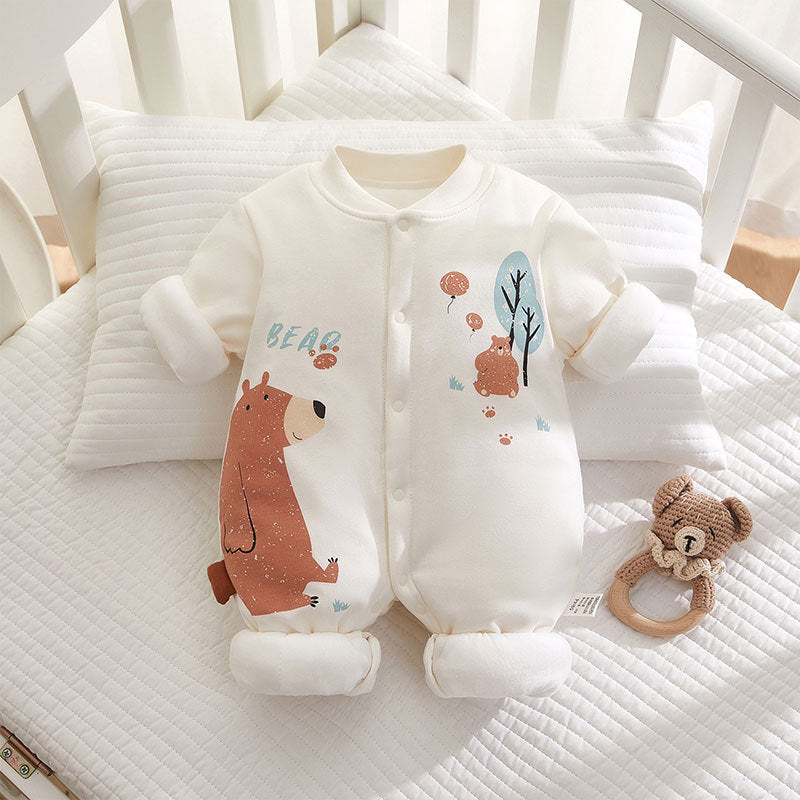 Baby onesie with bear design on a crib