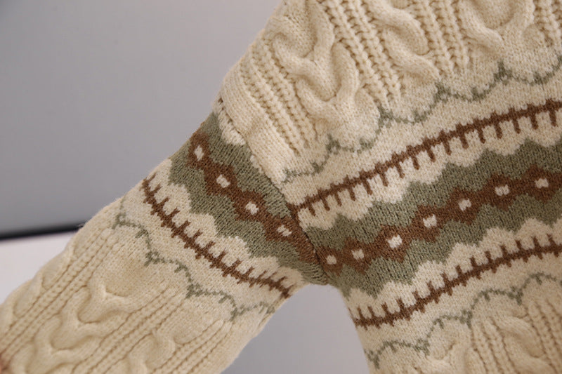 Close-up of a knitted sock with cable pattern and color-block design.