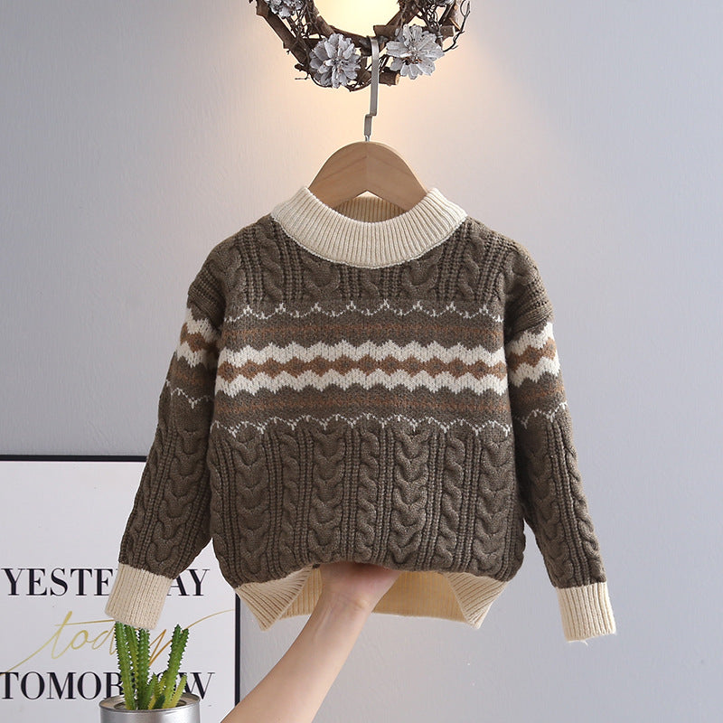 Brown and beige patterned sweater on a hanger against a neutral background