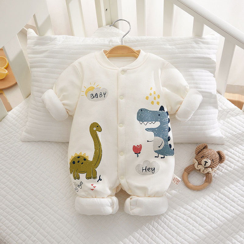 Baby onesie with dinosaur designs on a crib