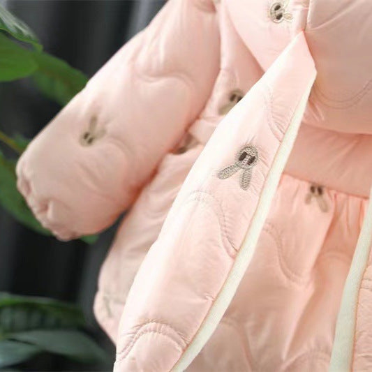 Close-up of a pink quilted jacket with a visible brand logo.