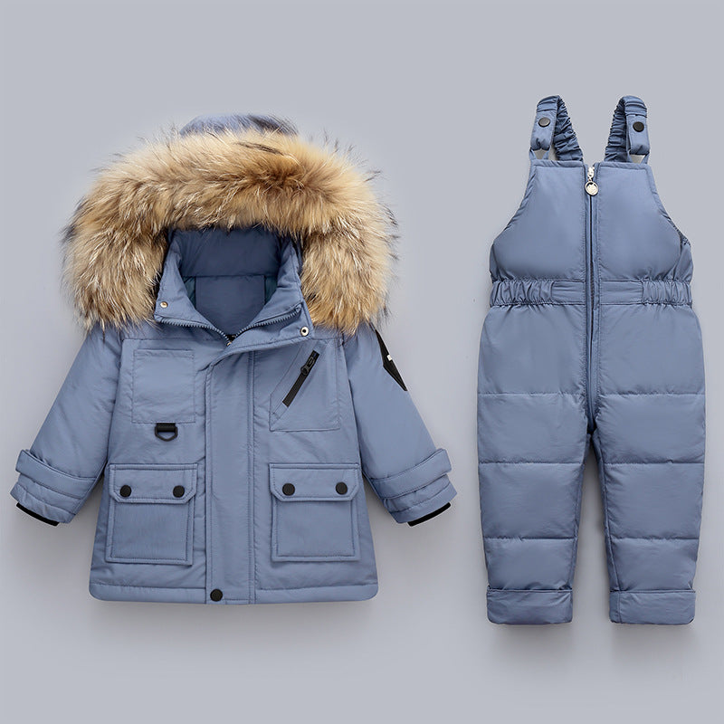 Blue winter coat with fur hood and matching snowsuit on a gray background