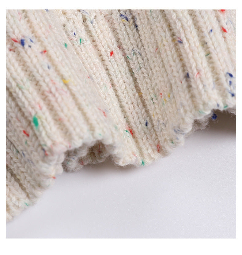 Close-up of a textured fabric with colorful speckles on a white background